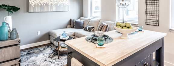 a living room with a kitchen and a couch and a table at Edge 35, Indianapolis, Indiana