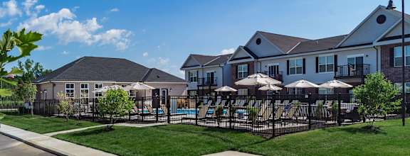 apartments with a swimming pool and a yard with umbrellas at Overland Park, Pickerington