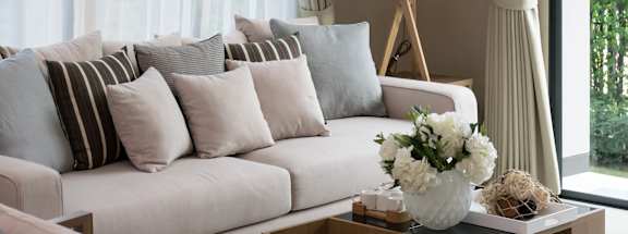 a living room with a white couch and a coffee table