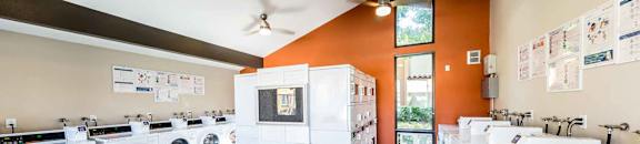 Large resident laundry room with new washing machines and clothes dryers at CASA GRANDE APARTMENT HOMES, Cypress, 90630