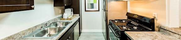 kitchen with new cabinetry and counter tops with new appliances at CASA GRANDE APARTMENT HOMES, Cypress, CA, 90630