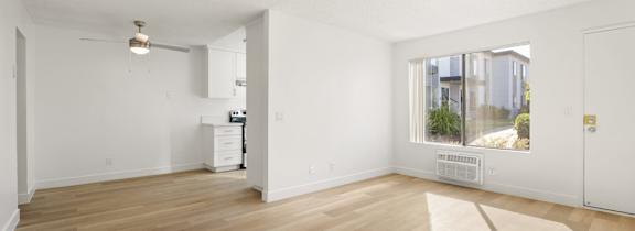 A living room with a white couch and a coffee table.
