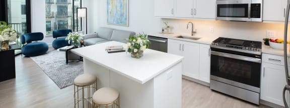 a kitchen with white cabinetry and a white island with a white countertop