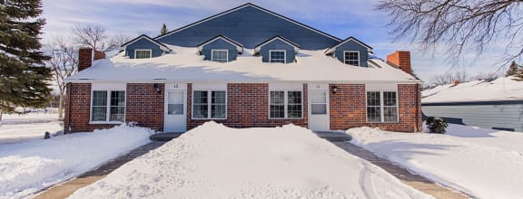 a home with a mound of snow in front of it  at Wellington Townhomes, Grand Forks, ND
