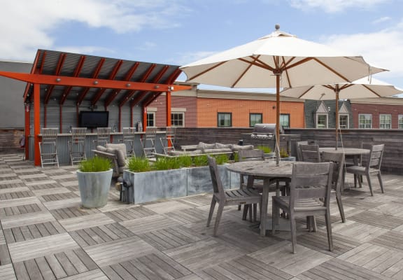 a roof deck with tables chairs and umbrellas  at Iron Works Sono, Norwalk, Connecticut