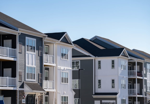 a row of townhomes with black roofs