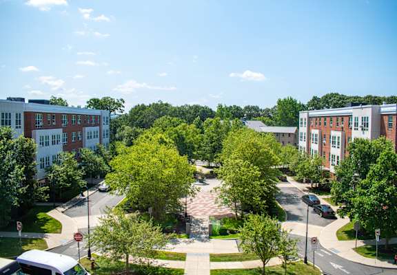 a large white building with a parking lot in front of it