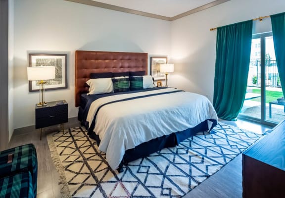 Comfortable bedroom with large windows at Berkshire Spring Creek in Garland, TX