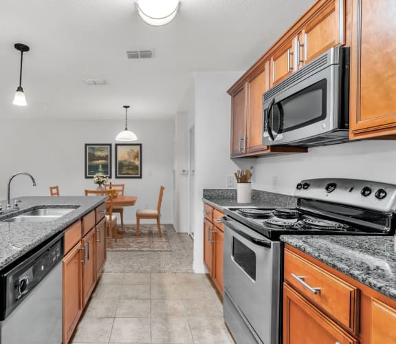 the kitchen has granite countertops and stainless steel appliances