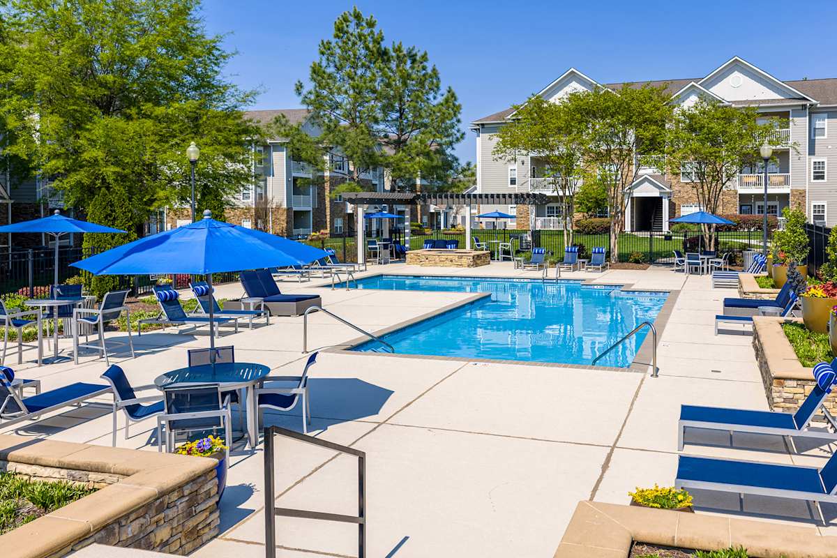Vintage Creekwood Park Apartments pool deck with umbrellas - Lenoir City, TN