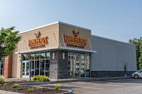 Exterior of Pancheros Mexican Grill—tan siding, stone accents and bright red logo—viewed from the parking lot.