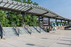 Wide granite steps and glass canopy at the entrance plaza of Fall River Depot commuter-rail station.