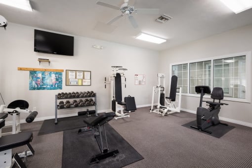 the heights at harper's preserve fitness center with exercise equipment and a flat screen tv