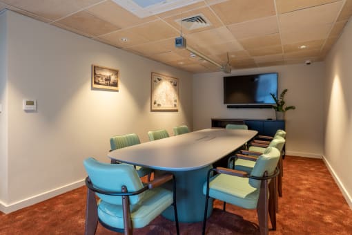 a meeting room with a large table and chairs