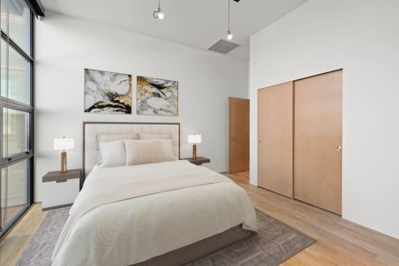 a bedroom with a large bed in a 555 waverly unit