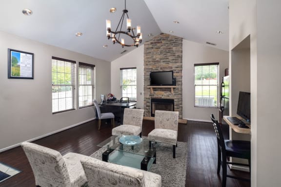 the view of a living room with a fireplace and a table with chairs