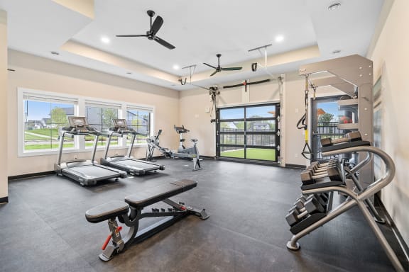 a resident fitness center with exercise bikes and a flat screen tv
