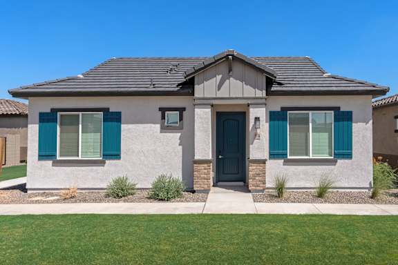 A house with a grey roof and a black front door.