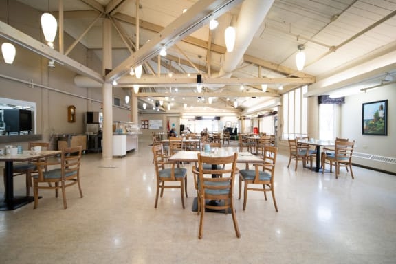 a large room with wooden tables and chairs