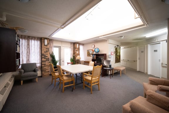 a room with a table and chairs and a fireplace