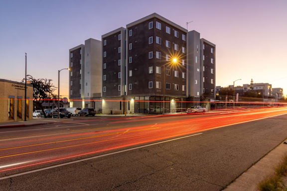 A long exposure shot of a street with a building in the background.