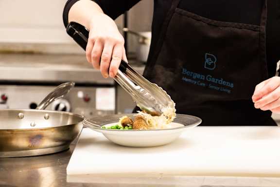 a chef prepares a dish in a kitchen