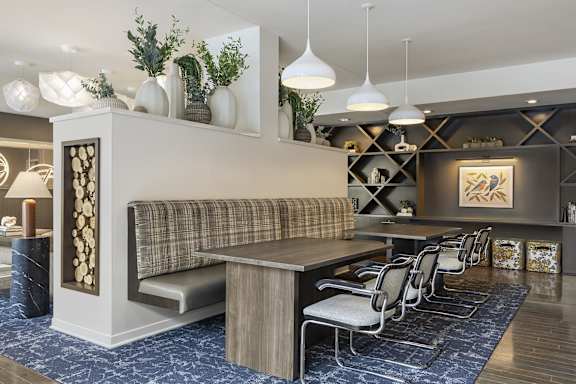 A modern living room with a grey sofa and a wooden table.