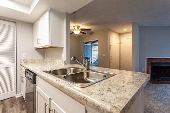 A floor plan of a house with a master bedroom, a living room, a dining area, a deck, and two bathrooms.