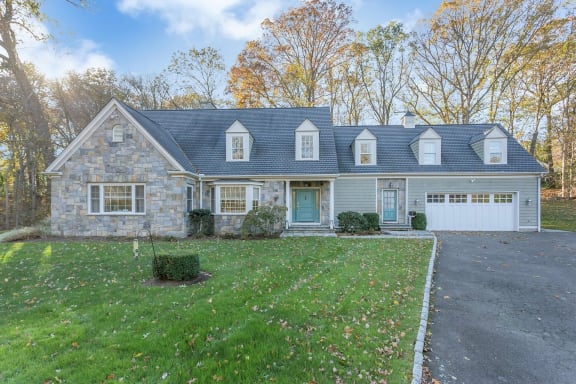 a home with a blue roof and a white garage door