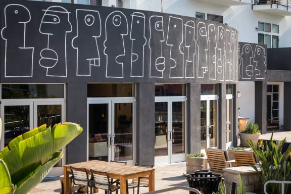 the facade of the building with tables and chairs