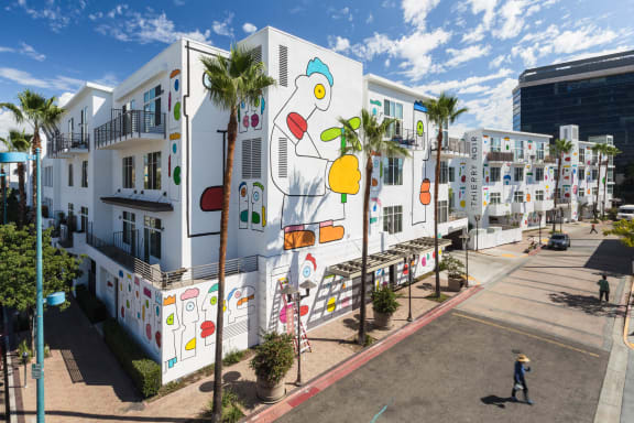 a building with a mural on it on the side of a street