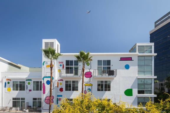 a building with palm trees and circles painted on it