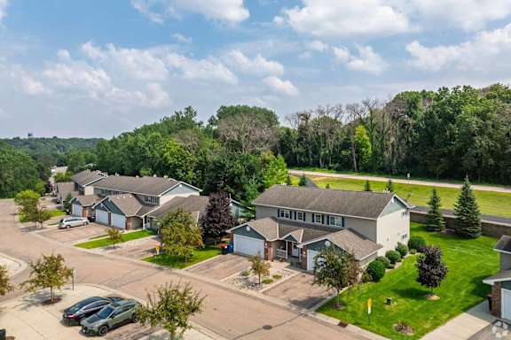A suburban neighborhood with houses and parked cars.