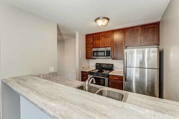 a kitchen with stainless steel appliances and a counter top