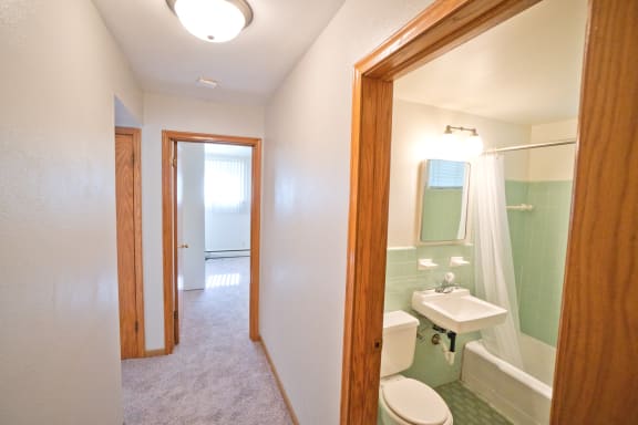 a bathroom with a white toilet next to a white sink