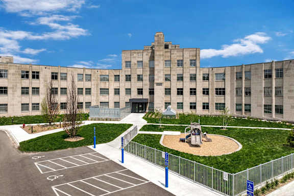 a large building with a playground in front of it