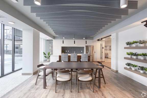 a dining room with a wooden table and chairs