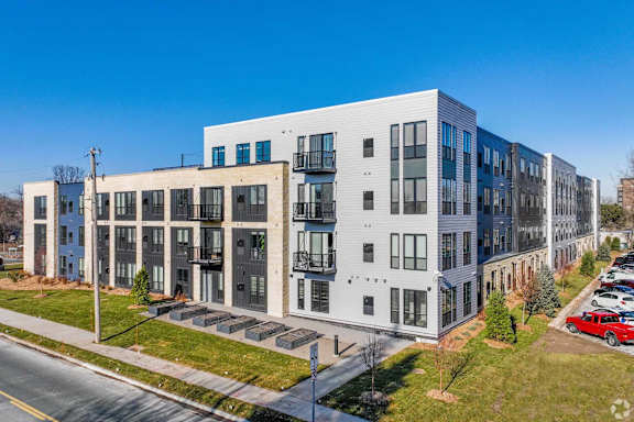 A modern apartment building with a mix of blue and white exterior.
