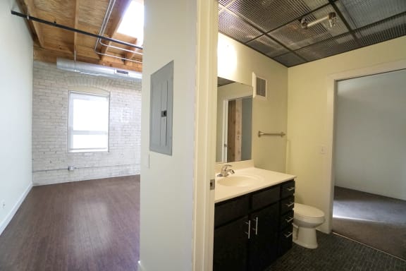 a bathroom with a toilet sink and mirror