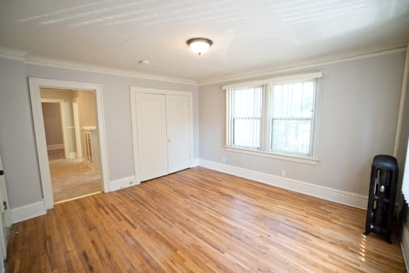 an empty living room with hardwood floors