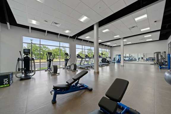a gym with a bunch of exercise equipment in it