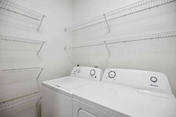 A white washing machine with three knobs on top.