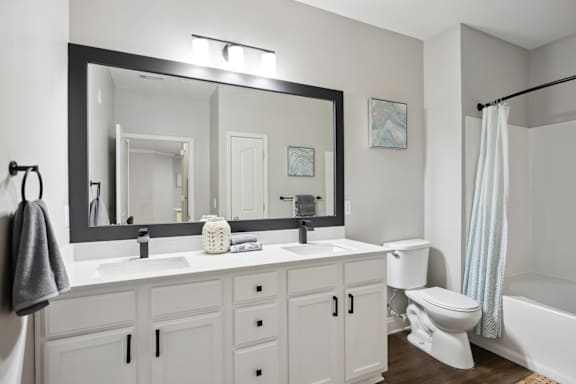 A bathroom with a white toilet and a white sink.