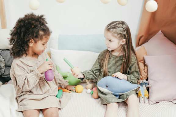 Two small girls playing together at 701 Hudson, California
