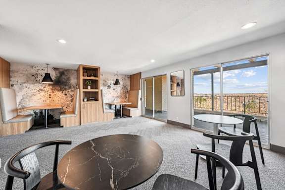A modern dining room with a round table and chairs. at The Lex At Lowry, Denver, Colorado