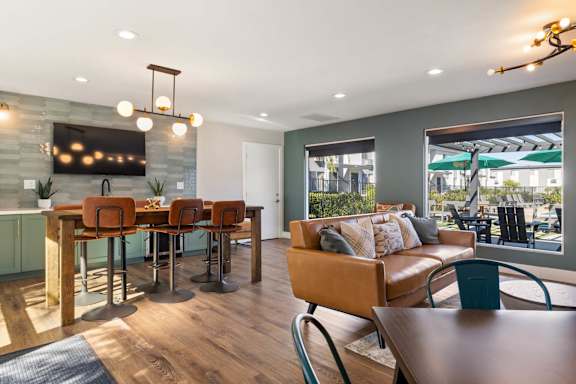 A modern dining room with a wooden table and chairs.