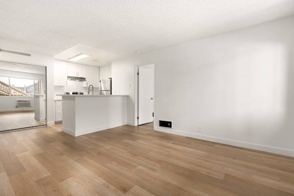 A room with wooden floors and white walls.