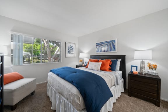 a living room with a blue couch and a sliding glass door