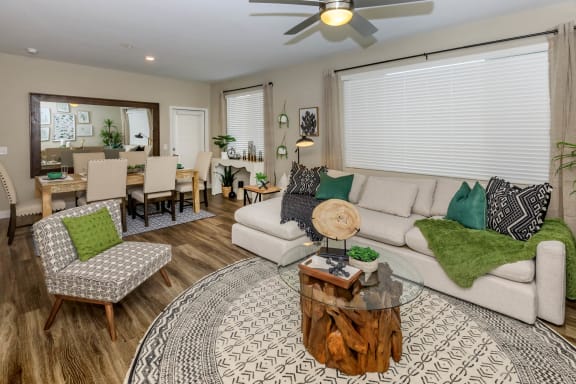 Living room with couch and wooden center table at Level 25 at Sunset by Picerne, Las Vegas, NV