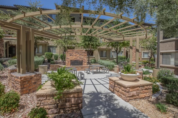 a patio with a fireplace and a pergola at The Pavilions by Picerne, Nevada